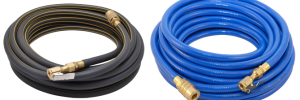 A black roll and a blue roll of pneumatic hoses with brass fittings