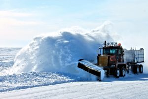 Snow plow clearing snow on street